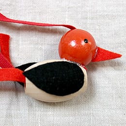 Closeup of red beaded bird necklace