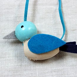 Closeup of blue beaded bird necklace