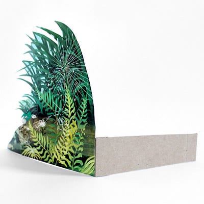 Image of foliage illustration being propped up by folded medium weight craft paper.