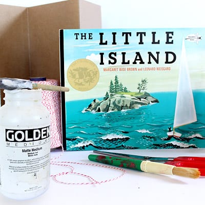 Materials needed to create The Little Island Accordion book: the book itself, modge podge, foam brush, paint brush, scissors, string, and medium weight craft paper.