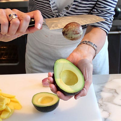 Seed removed from avocado with a chef knife.
