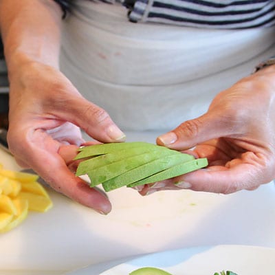 Avocado slices being fanned out.